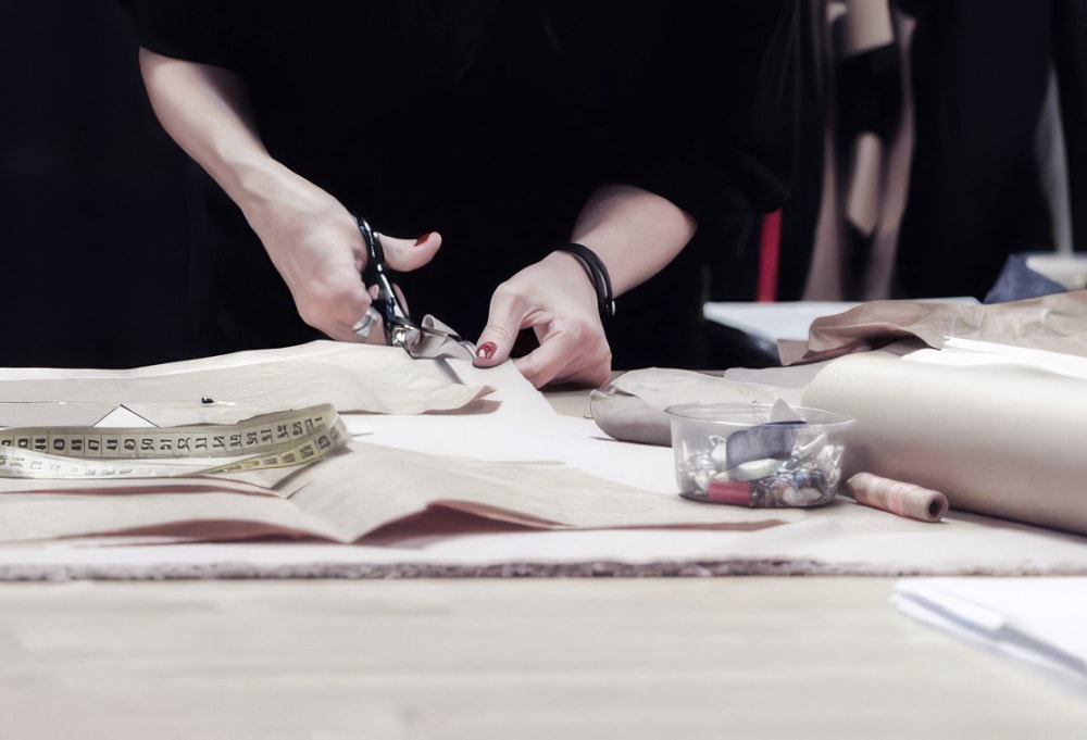 Manual cutting of material for a shapewear sample
